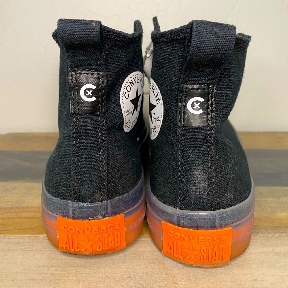 Black, clear and orange high top Converse. 7.5 in women